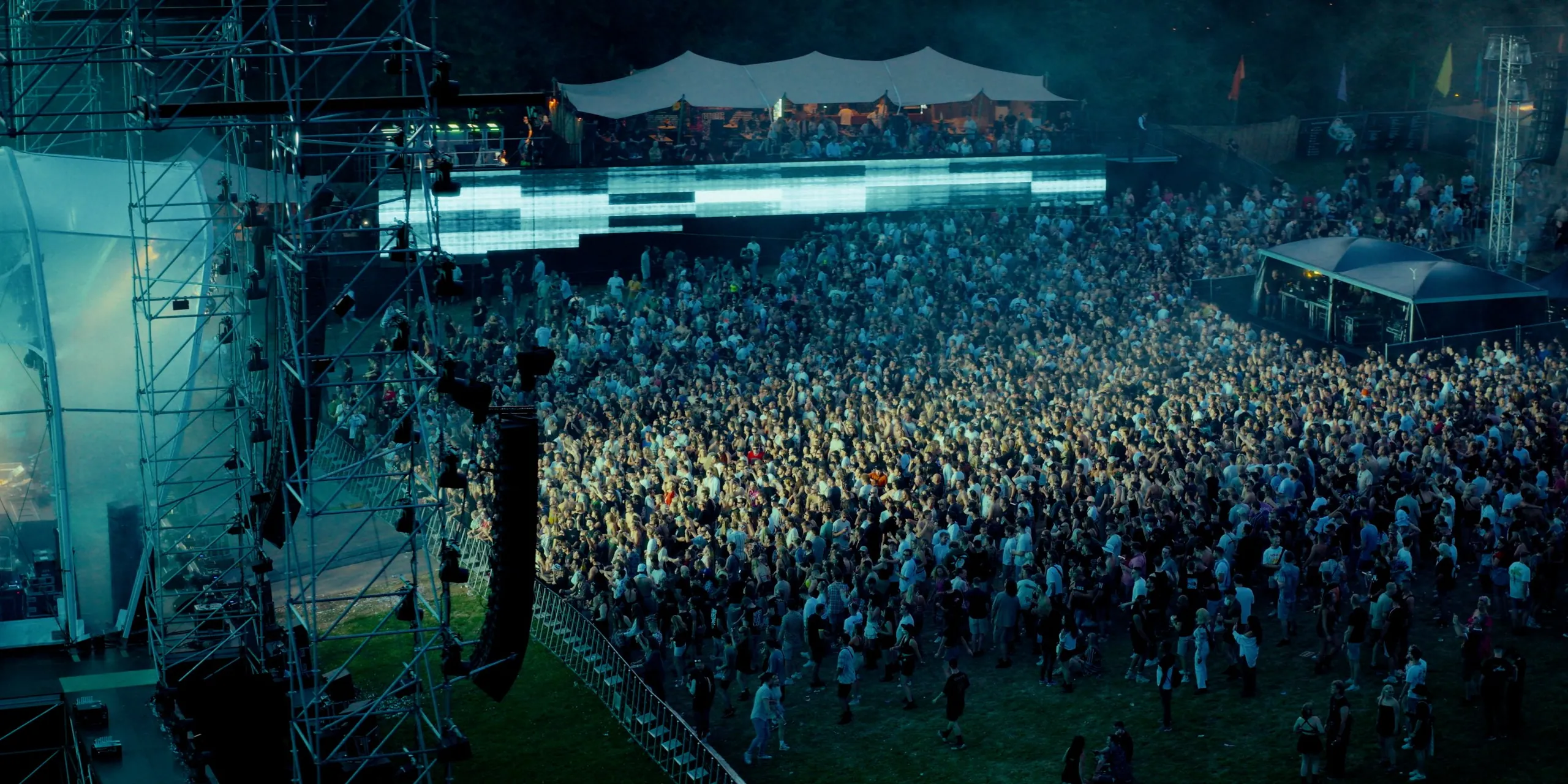 Dronefoto van festivalpubliek voor het hoofdpodium